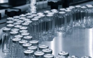 Pharmaceutical industry. Production line machine conveyor with glass bottles ampoules at factory. Pharmaceutical industry concept background.